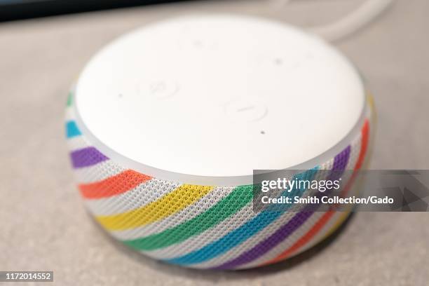 Close-up of newly-released Amazon Echo Dot Kids Edition smart speaker, designed for use by children, with rainbow color scheme, using the Alexa voice...