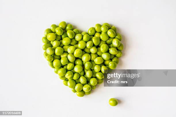 green peas in heart shape - legume family stock pictures, royalty-free photos & images