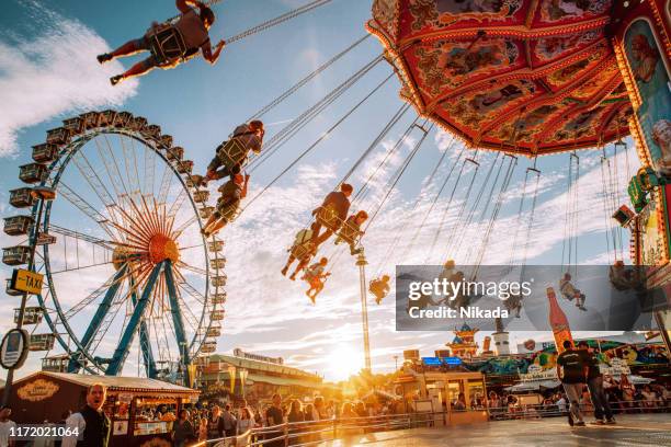 carousel at the oktoberfest in munich, germany - munich stock pictures, royalty-free photos & images
