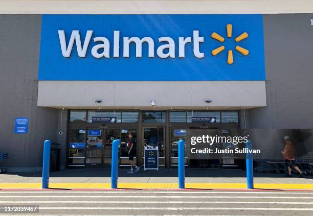 Customers enter a Walmart store on September 03, 2019 in San Leandro, California. Walmart, America's largest retailer, announced that it will reduce...