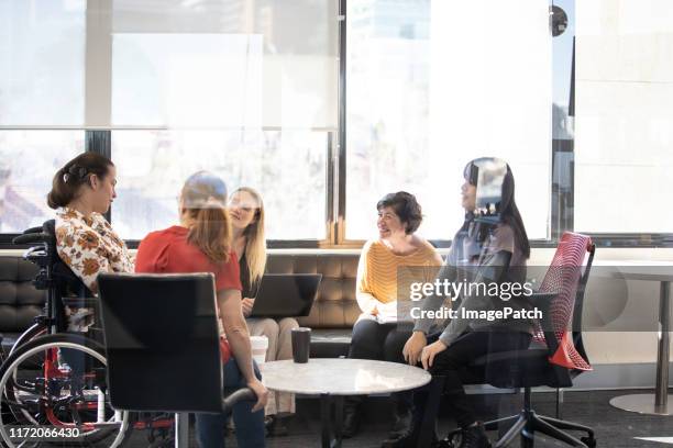 a group of professional women working collaboratively - community australia ストックフォトと画像