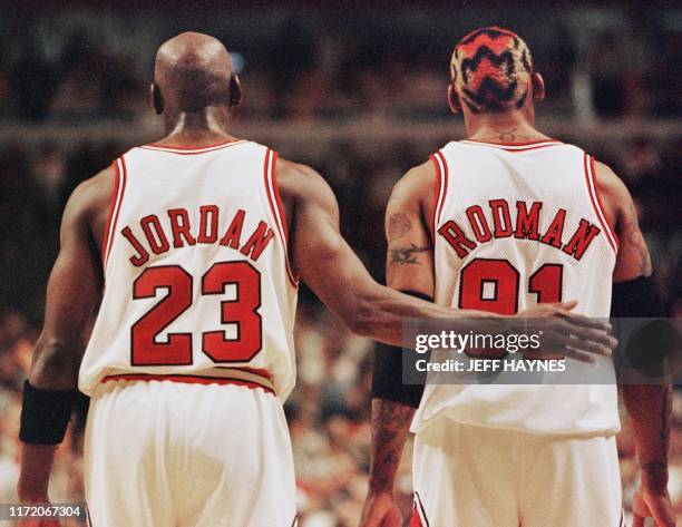 Michael Jordan pats Dennis Rodman , both of the Chicago Bulls, after Rodman was called for a technical foul 03 May during the second half of their...