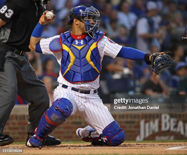 Willson Contreras of the Chicago Cubs throws back to the pitcher in his first game back from the injured list against the Seattle Mariners at Wrigley...