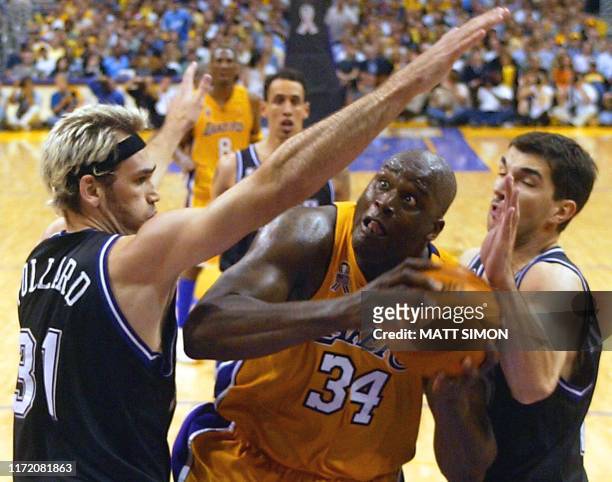 Peja Stojakovic and Scot Pollard of the Sacramento Kings defend against Shaquille O'Neal of the Los Angeles Lakers during 3rd quarter action of Game...