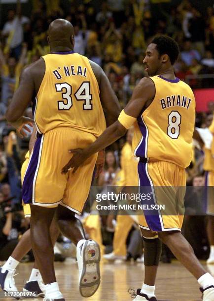 Los Angeles Lakers Kobe Bryant smacks Shaquille O'Neal on the buttocks during game two of the NBA Finals against the Philadelphia 76ers 08 June, 2001...