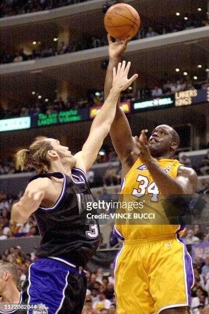 Shaquille O'Neal of the Los Angeles Lakers goes up for a shot as Scot Pollard of the Sacramento Kings defends during Game One of the NBA Western...