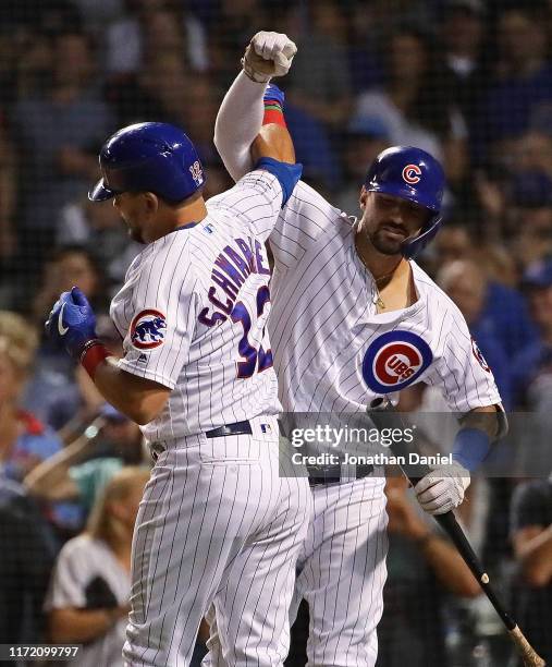 Kyle Schwarber and Nicholas Castellanos of the Chicago Cubs celebrate Schwarber's solo home run in the 7th inning against the Seattle Mariners at...