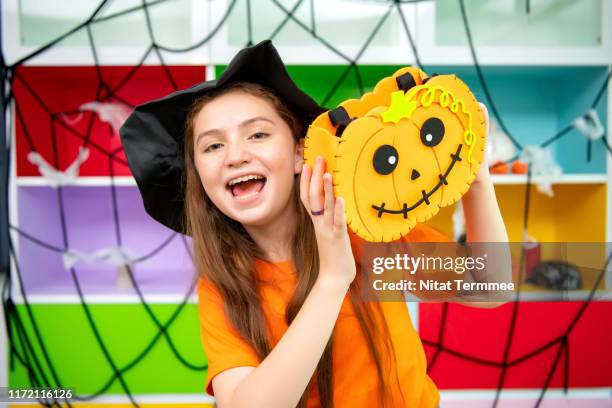 halloween. funny little girl in halloween costumes showing the tongue to the camera on halloween celebration. - little princess stock pictures, royalty-free photos & images