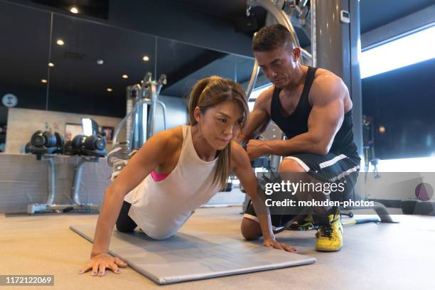 reife frau trainiert mit ihrem personal trainer. - push up japanese stock-fotos und bilder