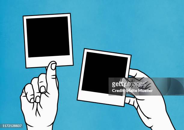 hands holding instant photographs - fotografische themen stock-grafiken, -clipart, -cartoons und -symbole