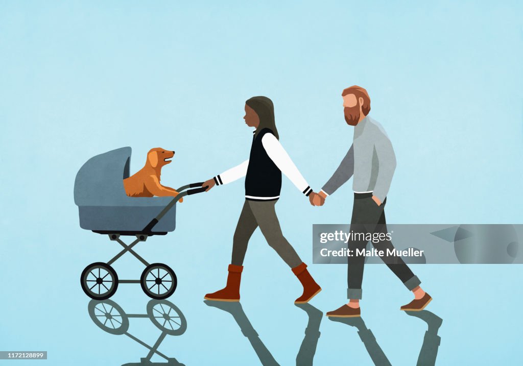 Couple holding hands and walking puppy in stroller