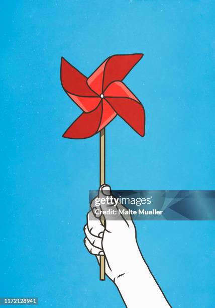 hand holding red pinwheel - paper windmill stock illustrations