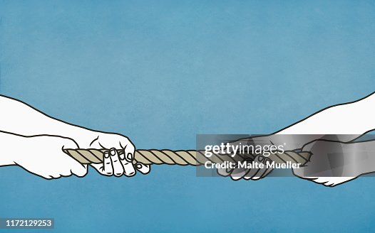 Couple playing tug-of-war with rope Couple playing tug-of-war with rope