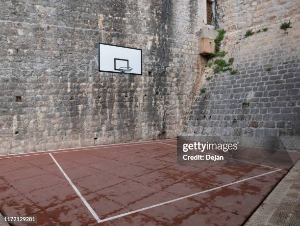 basketball court and hoop in stone courtyard - basketball court stock pictures, royalty-free photos & images