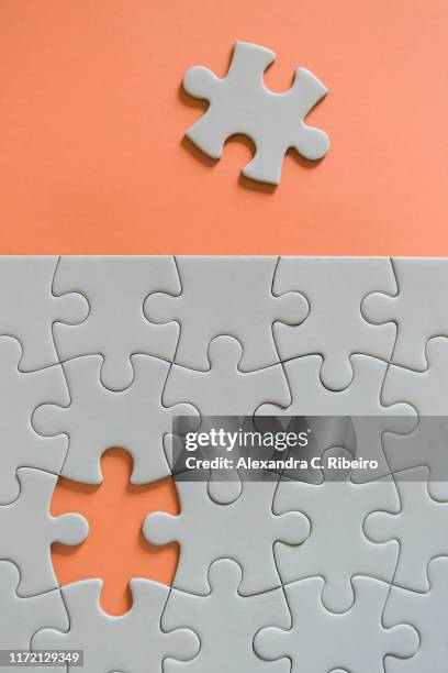 final missing jigsaw puzzle piece - puzzle imagens e fotografias de stock