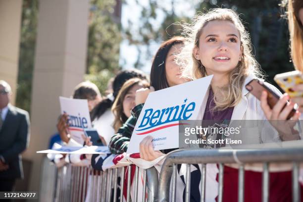 Supporters of Democratic presidential candidate, Sen. Bernie Sanders hold up signs during a campaign event at Plymouth State University on September...
