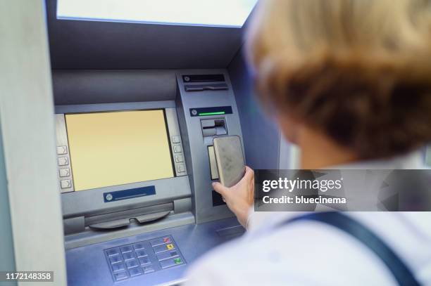 cash withdrawal - near field communication stock pictures, royalty-free photos & images