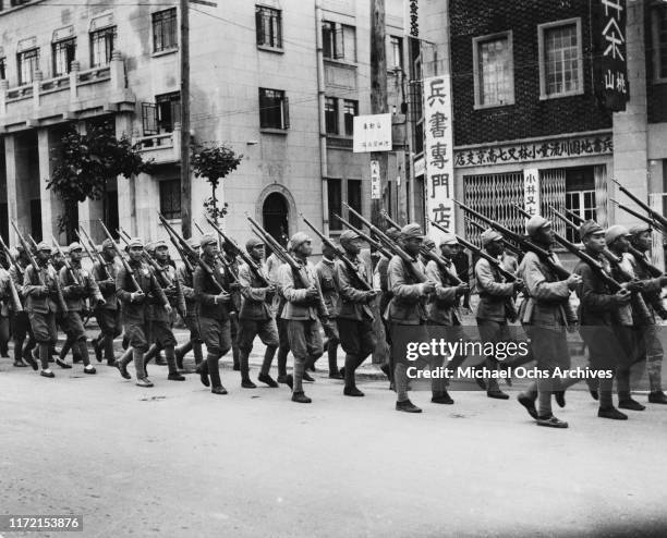 Chinese military units marching through the streets in Nanjing under the Wang Jingwei regime, a puppet state of the Empire of Japan, China, circa...