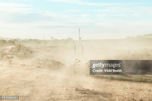 dust storm on a country road in the dry, drought area of australia - dust storm stock pictures, royalty-free photos & images