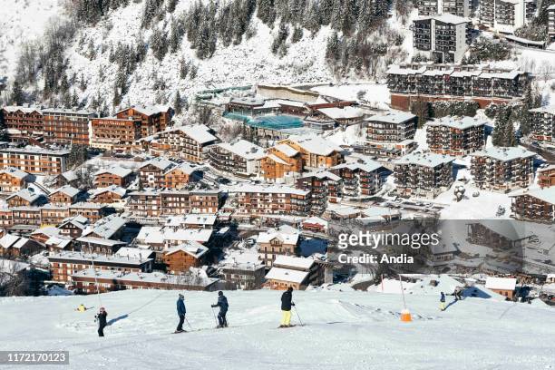 La Clusaz : the village covered in snow viewed from the upper ski runs of the ski resort.