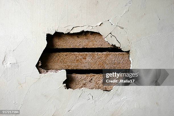 hole in plaster wall - exposed wood paneling - plaster construction material stock pictures, royalty-free photos & images
