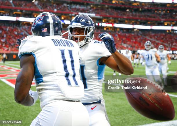 Brown and Jonnu Smith of the Tennessee Titans celebrate after Brown scored a touchdown in the first half of an NFL game against the Atlanta Falcons...