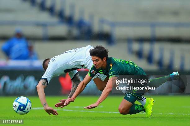 Juan Iturbe of Pumas struggles for the ball with Carlos Orrantia of Santos Laguna during the 12th round match between Pumas UNAM and Santos Laguna as...