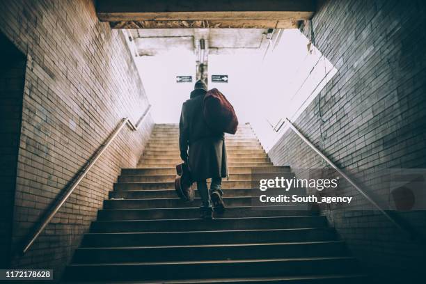 street performer walking up the steps - homeless stock pictures, royalty-free photos & images