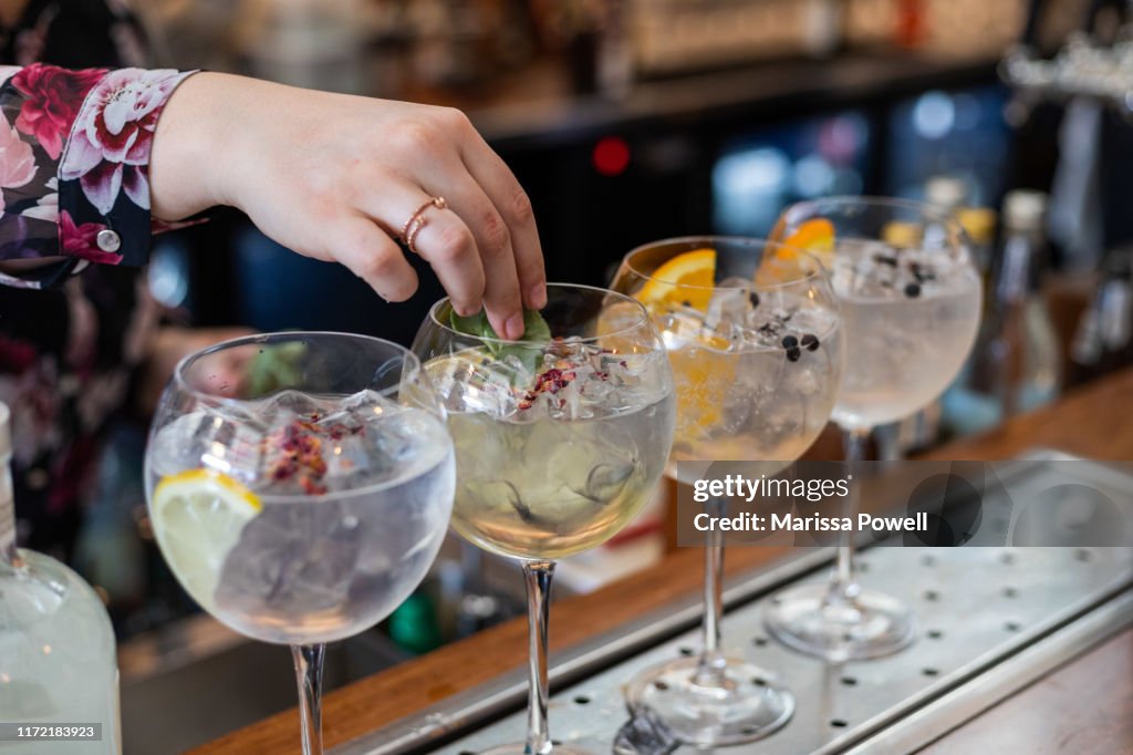 Garnish being placed in a gin cocktail