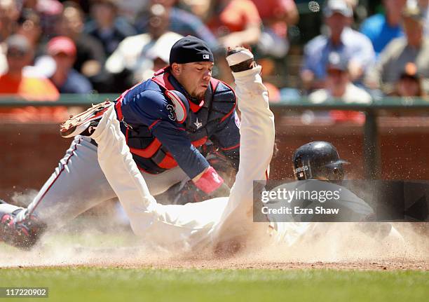 Rene Rivera of the Minnesota Twins tags out Emmanuel Burriss of the San Francisco Giants at home plate in the seventh inning at AT&T Park on June 23,...