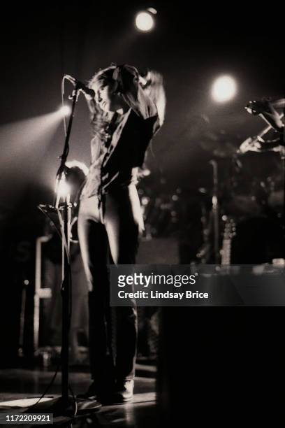 Vocalist Hope Sandoval cradles her head with her left arm as she performs in Mazzy Star at the Hollywood Palladium on November 26, 1994 in Los...