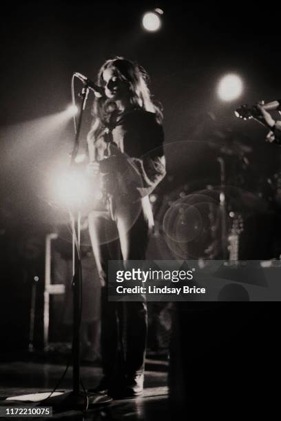 Vocalist Hope Sandoval brings her hands together as she performs in Mazzy Star at the Hollywood Palladium on November 26, 1994 in Los Angeles.