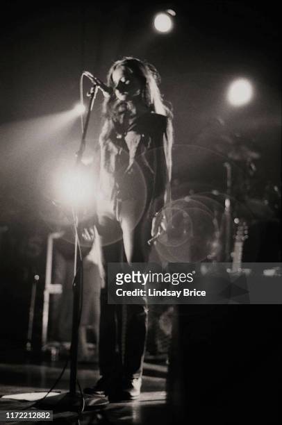 Vocalist Hope Sandoval stands with both arms down as she performs in Mazzy Star at the Hollywood Palladium on November 26, 1994 in Los Angeles.