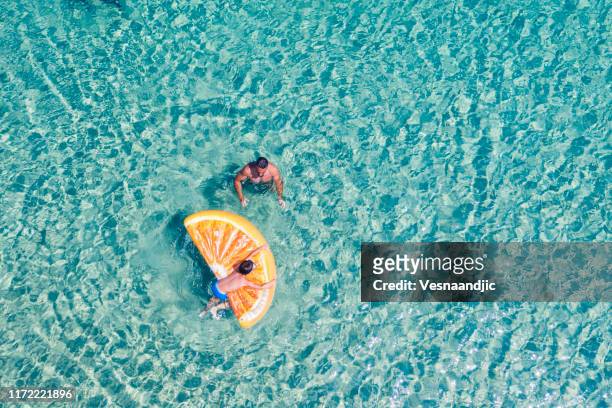 drone view of swimming people - heavenly resort stock pictures, royalty-free photos & images
