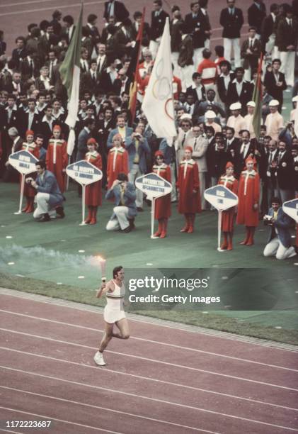 Sergei Belov of the Soviet Union runs with the Olympic Torch during the Opening Ceremony event for the XXII Olympic Summer Games on 19 July 1980 at...