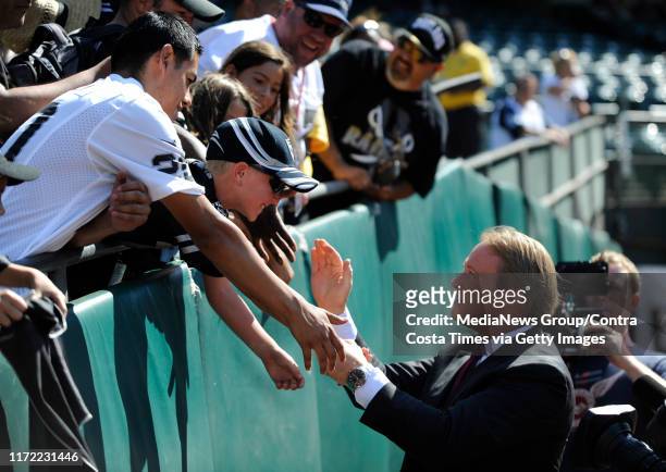 Foremer Raiders coach Jon Gruden, now an ESPN broadcaster, shakes hands with fans before the Oakland Raiders vs. Dallas Cowboys preseason game at...