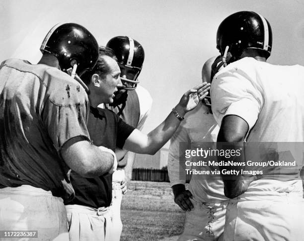 Oakland, CA July 20, 1964 - Al Davis instructs his players during training. &#13;