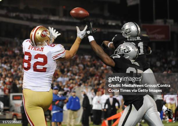 San Francisco 49ers Nate Byham, #82, reaches over Oakland Raiders Stevie Brown, #27, to score the two-point conversion in the fourth quarter of their...