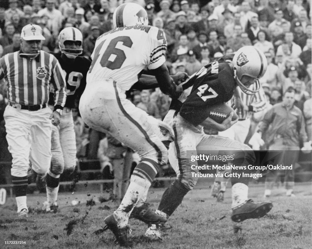 November 14, 1965 Oakland, CA - Oakland Raiders defensive back Kent McCloughan #47, is tackled by Buffalo Bills Bo Roberson. (by Russ Reed / Oakland Tribune)
