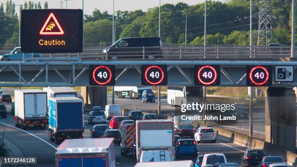 warning signs on the m1 motorway, hertfordshire.england. - speed limit sign stock pictures, royalty-free photos & images