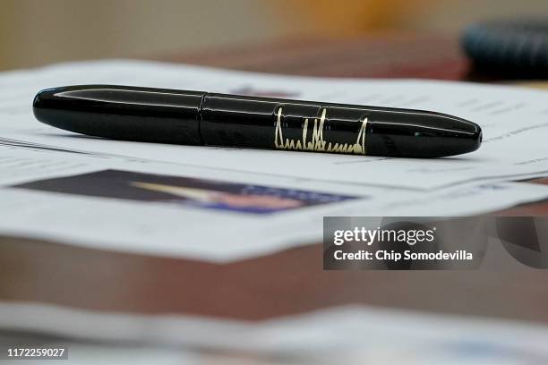 Pen with U.S. President Donald Trump's signature printed on the side sits on the Resolute Desk following a briefing about Hurricane Dorian in the...