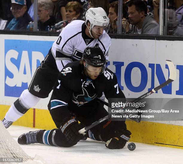 San Jose Sharks defenseman Brad Stuart battles the Los Angeles Kings' Mike Richards for the puck during the third period of Game 5 of an NHL hockey...