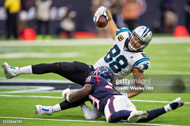 Greg Olsen of the Carolina Panthers is tackled by Tashaun Gipson Sr. #39 of the Houston Texans during a game at NRG Stadium on September 29, 2019 in...