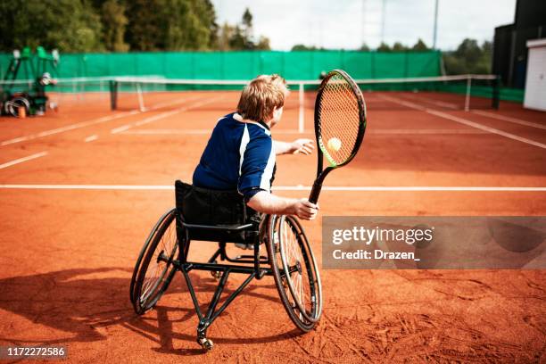 adult man in wheelchair playing tennis - wheelchair sport stock pictures, royalty-free photos & images