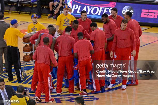 Los Angeles Clippers remove their warm up jackets in sign of protest over the alleged racist remarks made by their owner Donald Sterling before...