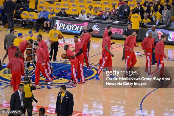 Los Angeles Clippers remove their warm up jackets in sign of protest over the alleged racist remarks made by their owner Donald Sterling before...