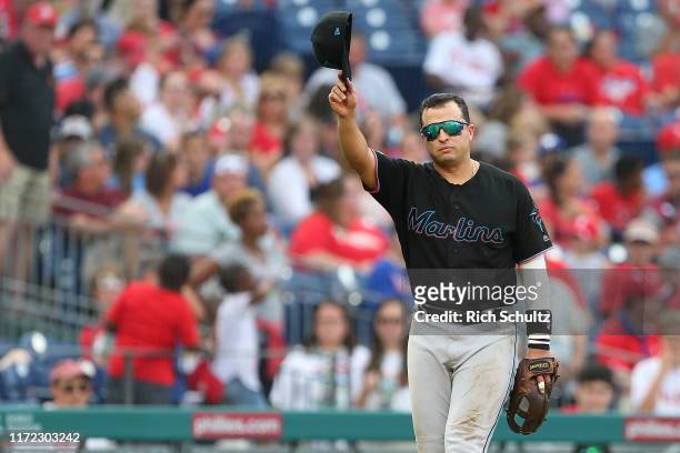 Martin Prado of the Miami Marlins tips his cap after he was removed from the game during the ninth inning against the Philadelphia Phillies at...