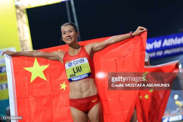China's Liu Hong celebrates after winning the Women's 20km Race Walk final at the 2019 IAAF World Athletics Championships in Doha on September 29,...