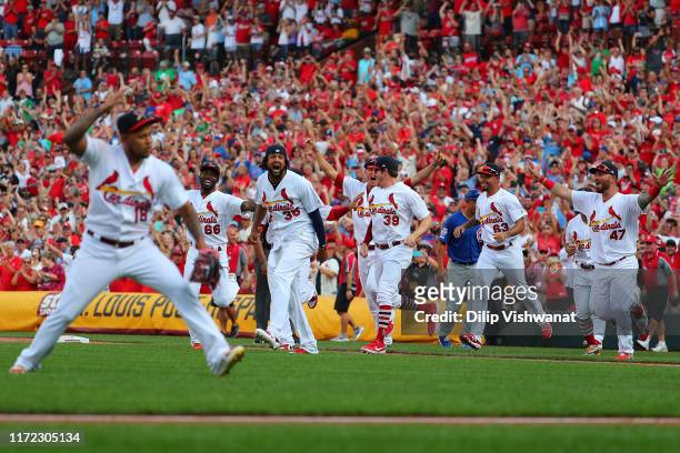 Jose Martinez of the St. Louis Cardinals and teammates celebrate winning the National League Central Division after beating the Chicago Cubs at Busch...