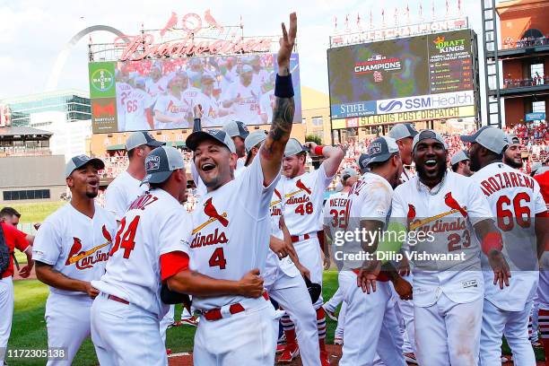 Yadier Molina and Jose Martinez of the St. Louis Cardinals celebrate winning the National League Central Division after beating the Chicago Cubs at...